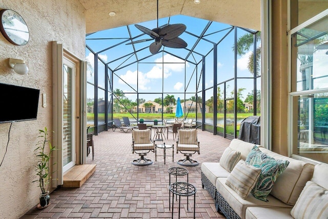 view of patio featuring glass enclosure and outdoor lounge area