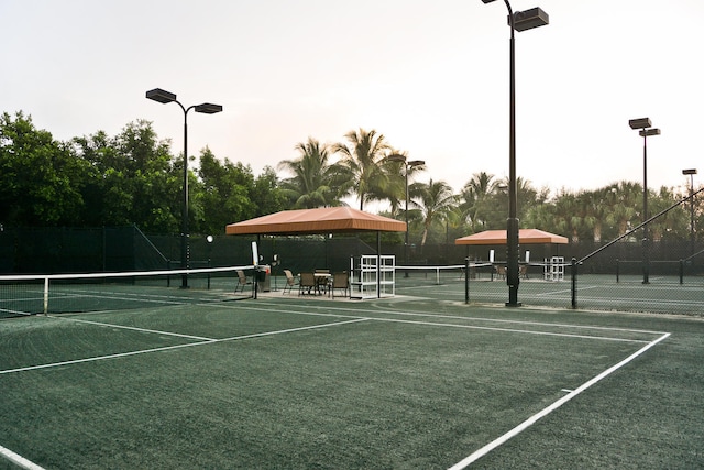 view of sport court featuring fence