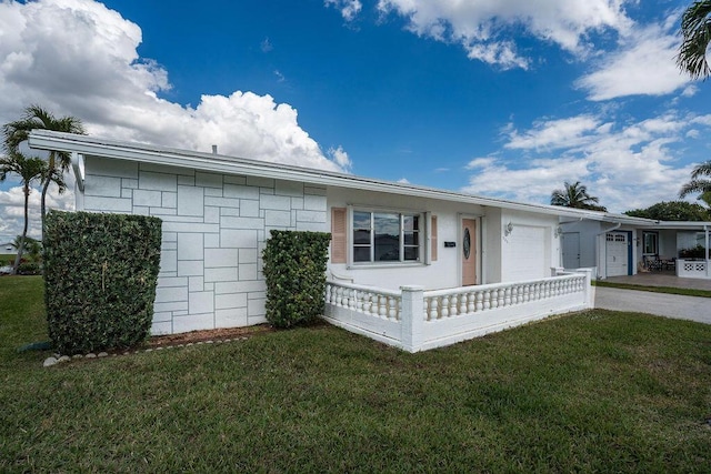 ranch-style home with a front lawn, driveway, and an attached garage