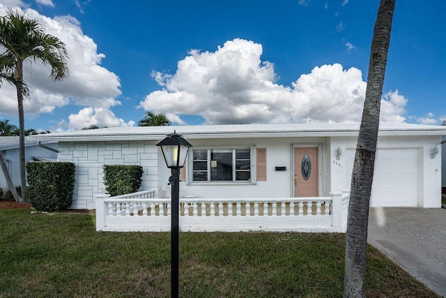 ranch-style house featuring a front lawn and an attached garage