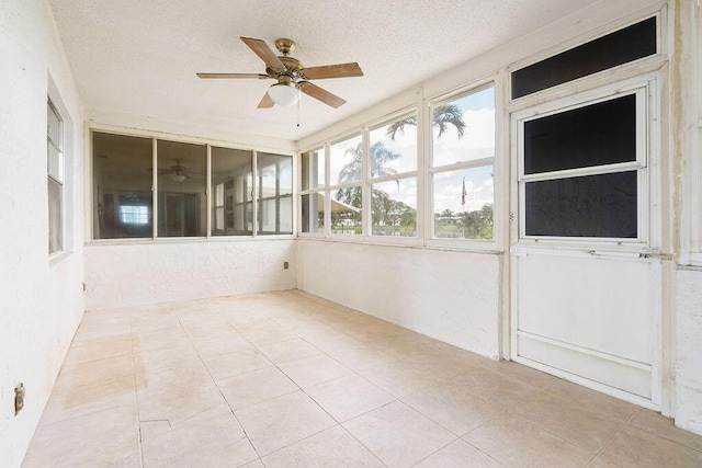 unfurnished sunroom with a ceiling fan