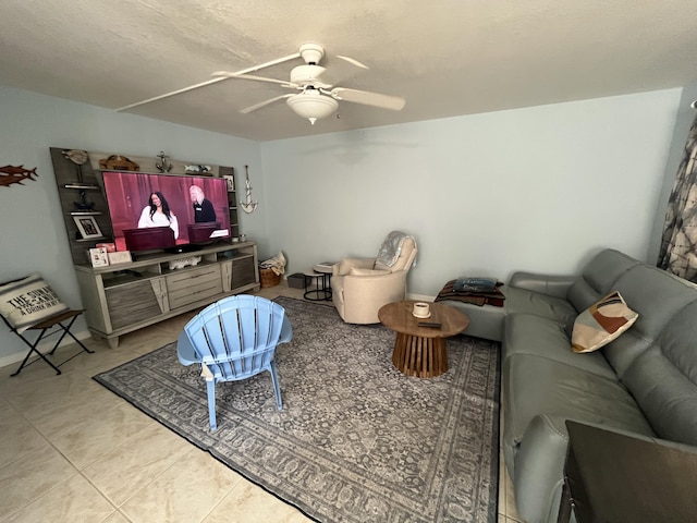 living room with a ceiling fan and light tile patterned flooring