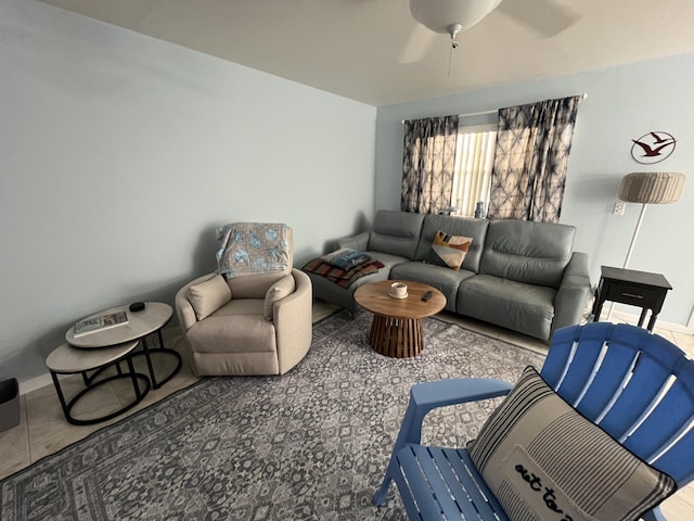 living room with a ceiling fan and baseboards