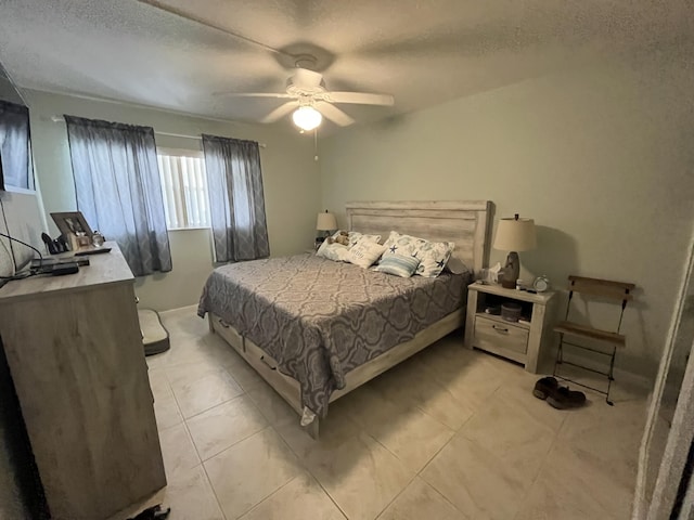 bedroom with a textured ceiling and ceiling fan