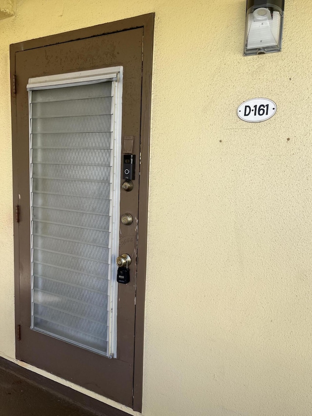 entrance to property with stucco siding