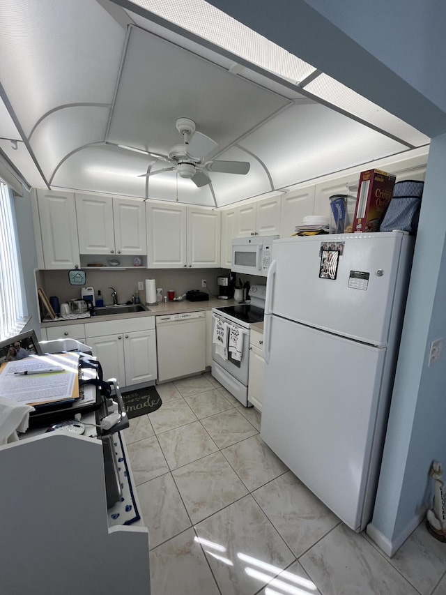 kitchen with ceiling fan, white appliances, a sink, and white cabinetry