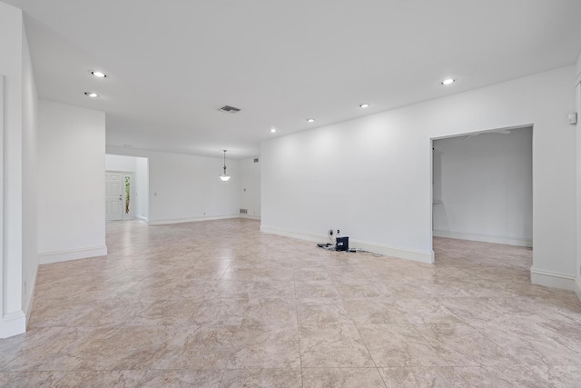 unfurnished room featuring baseboards, visible vents, and recessed lighting