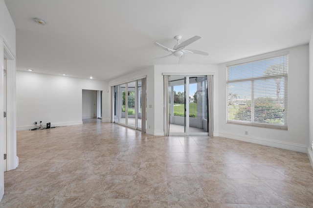 empty room with ceiling fan, baseboards, and recessed lighting