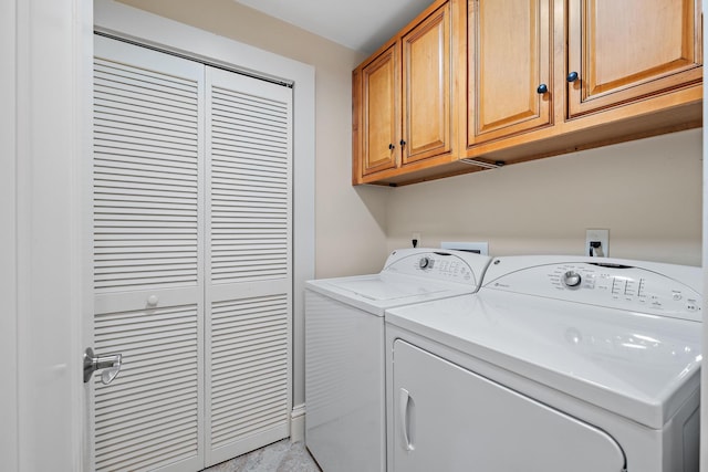 laundry area with cabinet space and independent washer and dryer