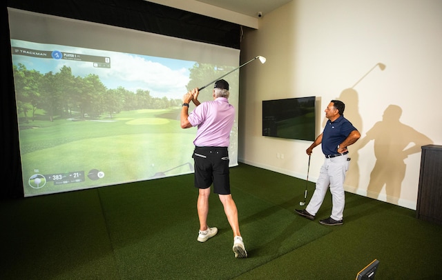 playroom featuring golf simulator and baseboards