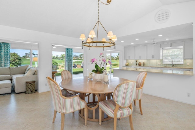 dining space featuring vaulted ceiling, a notable chandelier, and recessed lighting