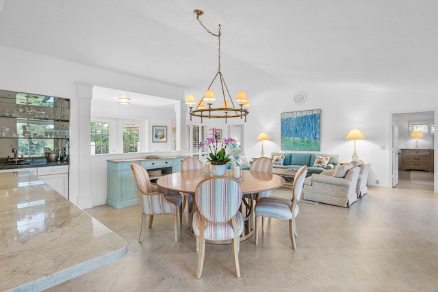 dining area featuring lofted ceiling and an inviting chandelier