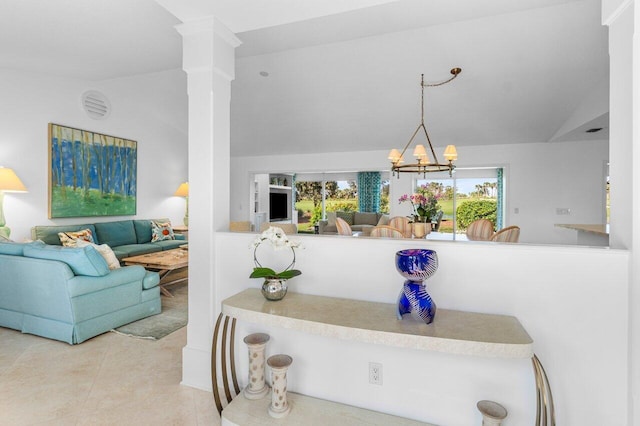 interior space with vaulted ceiling and an inviting chandelier