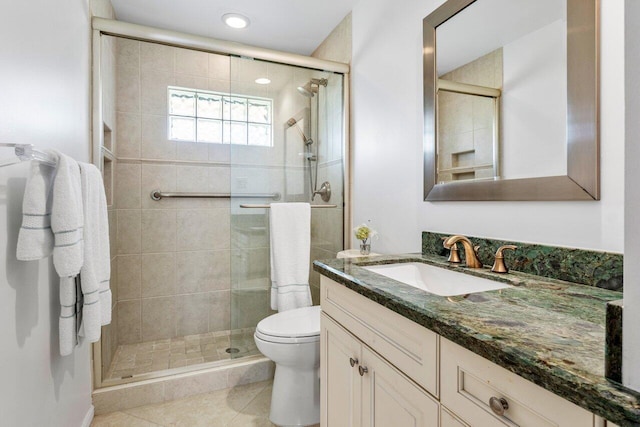 bathroom with vanity, tile patterned flooring, a shower stall, and toilet