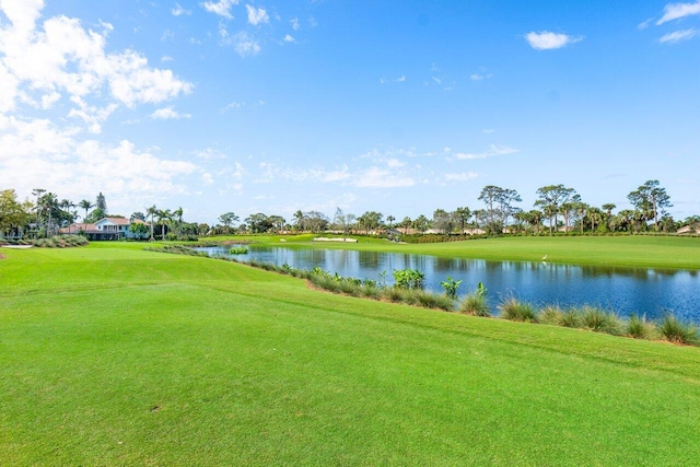 view of home's community featuring a lawn and a water view