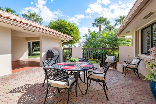 view of patio with outdoor dining area and area for grilling