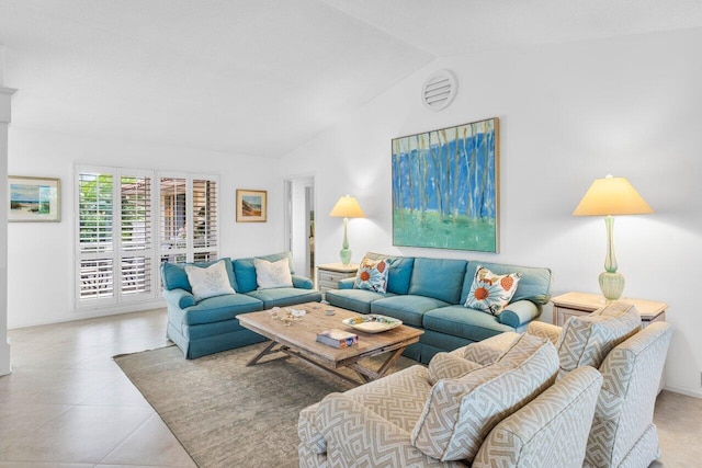 living area featuring lofted ceiling and tile patterned flooring