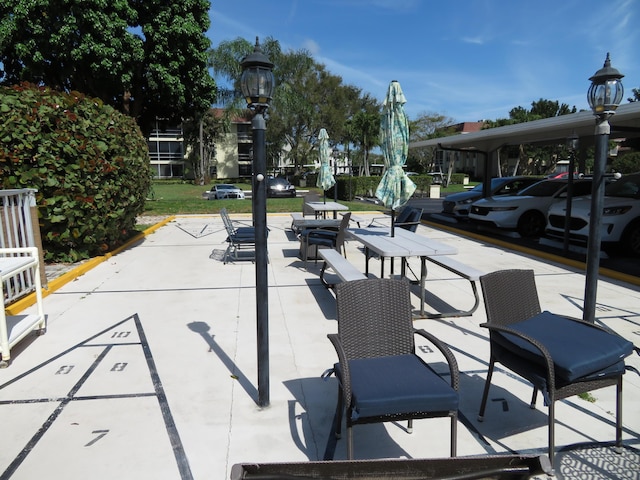5580 Tamberlane Cir Unit 334, Palm Beach Gardens, FL 33418 - surrounding community with shuffleboard and a parking lot