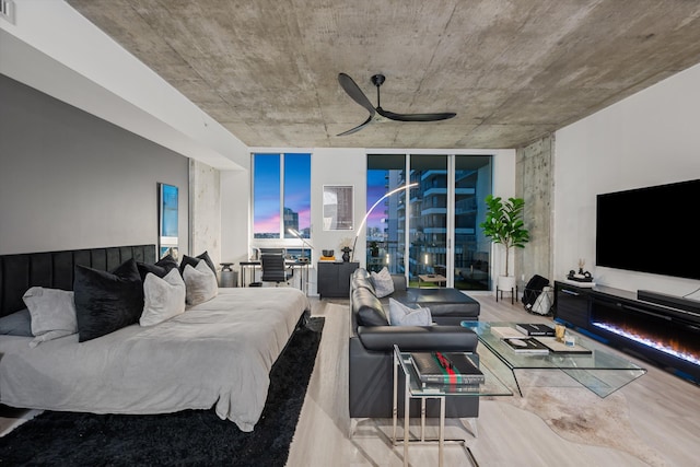 living area featuring visible vents, ceiling fan, and wood finished floors