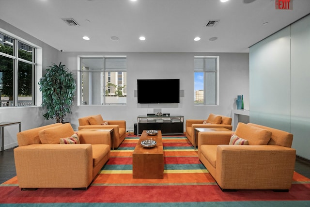 living area with visible vents, a wealth of natural light, and recessed lighting