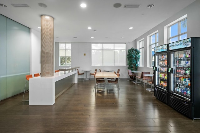 dining space with beverage cooler, wood finished floors, visible vents, and recessed lighting