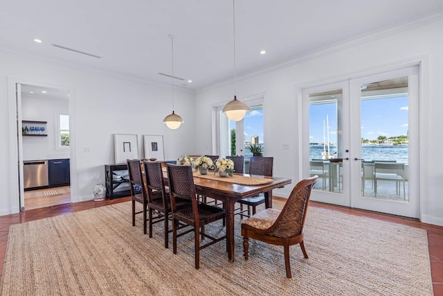 dining space with baseboards, ornamental molding, a water view, french doors, and recessed lighting