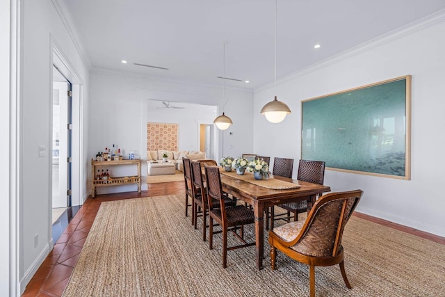 dining room with dark tile patterned flooring, crown molding, baseboards, and recessed lighting