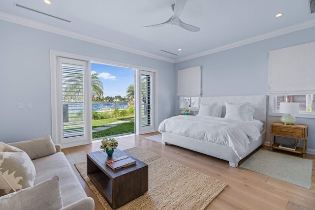 bedroom featuring ornamental molding, light wood-type flooring, visible vents, and access to exterior