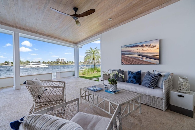 view of patio featuring a water view, an outdoor hangout area, and a ceiling fan