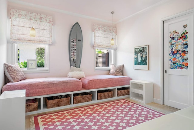 mudroom with light wood-type flooring, baseboards, and ornamental molding