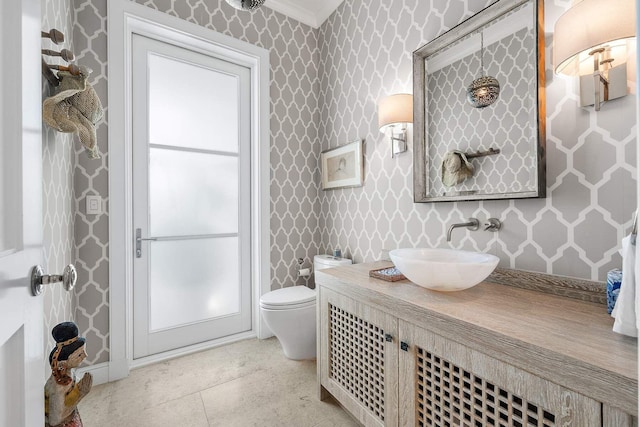 bathroom with tile patterned floors, vanity, toilet, and wallpapered walls