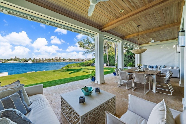 view of patio featuring ceiling fan, outdoor lounge area, outdoor dining space, and a water view