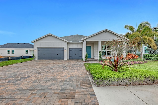 view of front of home featuring an attached garage, decorative driveway, and board and batten siding