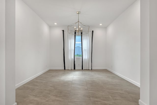 empty room with a chandelier, recessed lighting, and baseboards