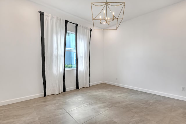 unfurnished room featuring baseboards and an inviting chandelier