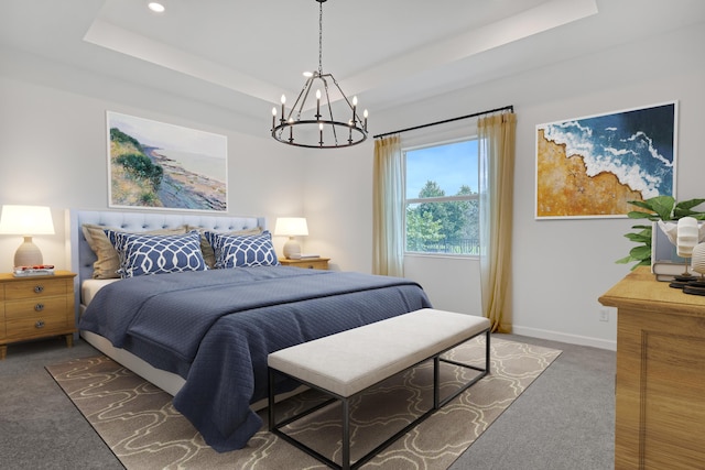 bedroom with baseboards, a tray ceiling, and dark carpet