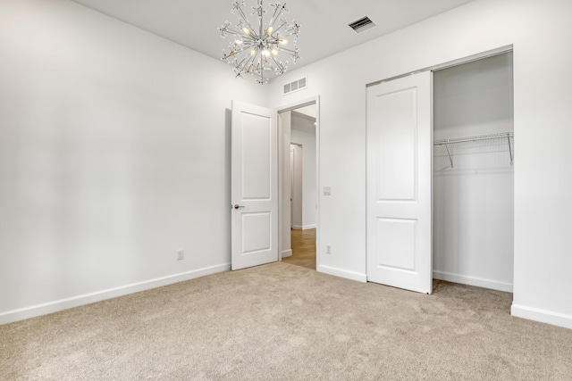 unfurnished bedroom with a closet, visible vents, light carpet, and baseboards