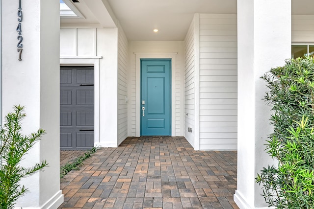 doorway to property featuring stucco siding