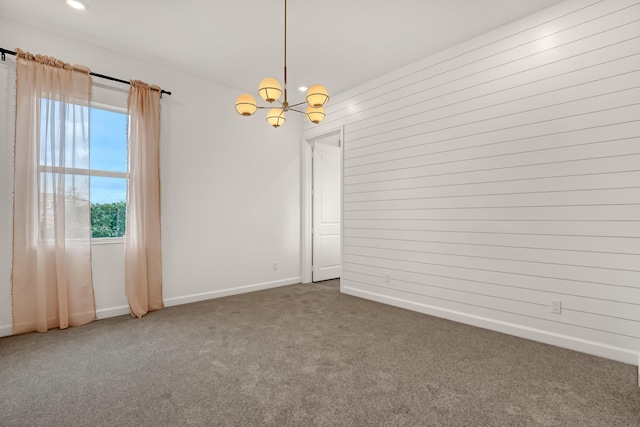 carpeted empty room featuring a chandelier, recessed lighting, and baseboards