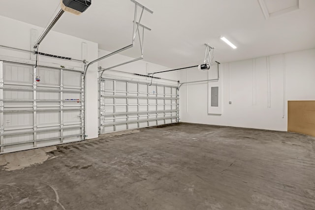 garage with a garage door opener and electric panel