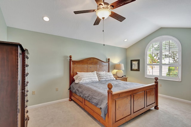 bedroom with a ceiling fan, lofted ceiling, light carpet, and baseboards