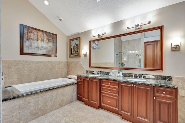 bathroom with vaulted ceiling, double vanity, a sink, and a bath