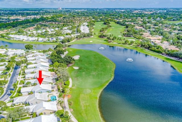 birds eye view of property with view of golf course, a water view, and a residential view