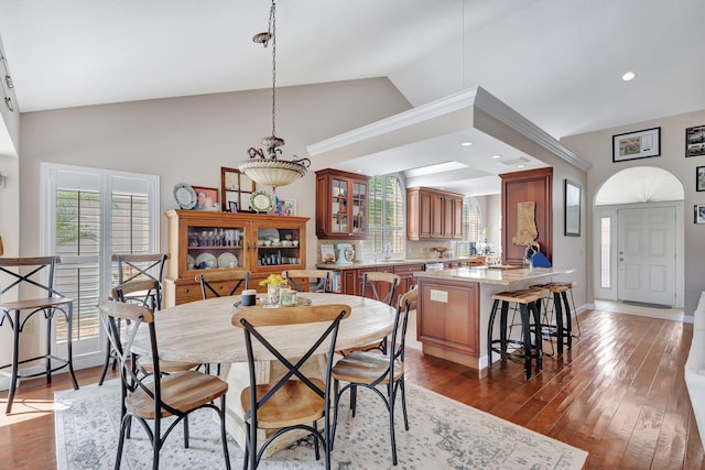 dining room with high vaulted ceiling, recessed lighting, dark wood finished floors, and baseboards