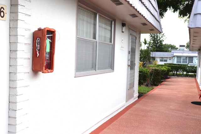 entrance to property with stucco siding