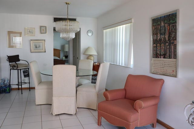 dining area featuring tile patterned floors, visible vents, baseboards, and a notable chandelier