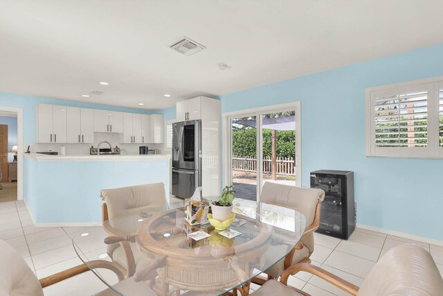 dining room with wine cooler, light tile patterned floors, recessed lighting, visible vents, and baseboards