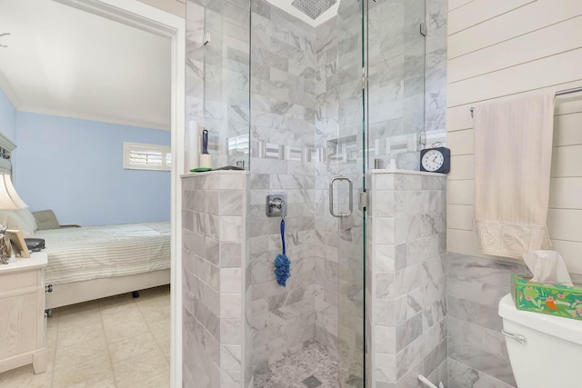 ensuite bathroom featuring crown molding, toilet, a shower stall, ensuite bath, and vanity