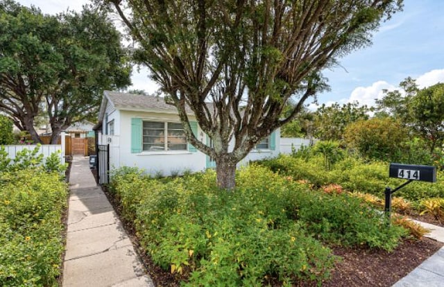 view of property exterior with fence and stucco siding