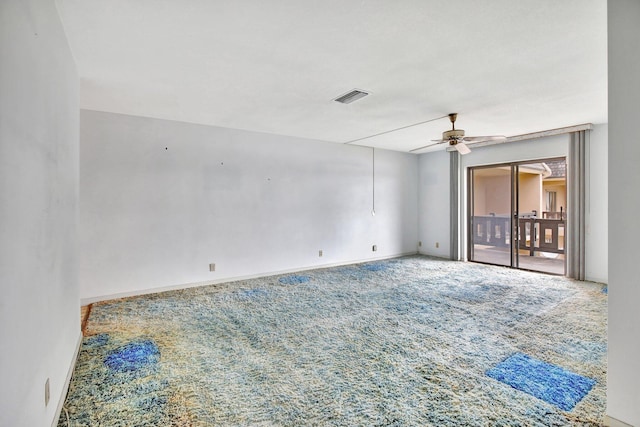 spare room featuring carpet, visible vents, ceiling fan, and baseboards